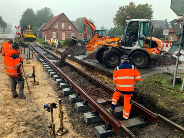 082 Foto Jens B.<br />17:34 Uhr: Da die Baufirma nicht mehr vor Ort ist, kommt der Werkstattralf &quot;mal eben&quot; mit dem Radlader von Vilsen, um uns das Gleis zu verfüllen.<br />Kalle und der Rottenralf warten schon mit den Schaufeln.